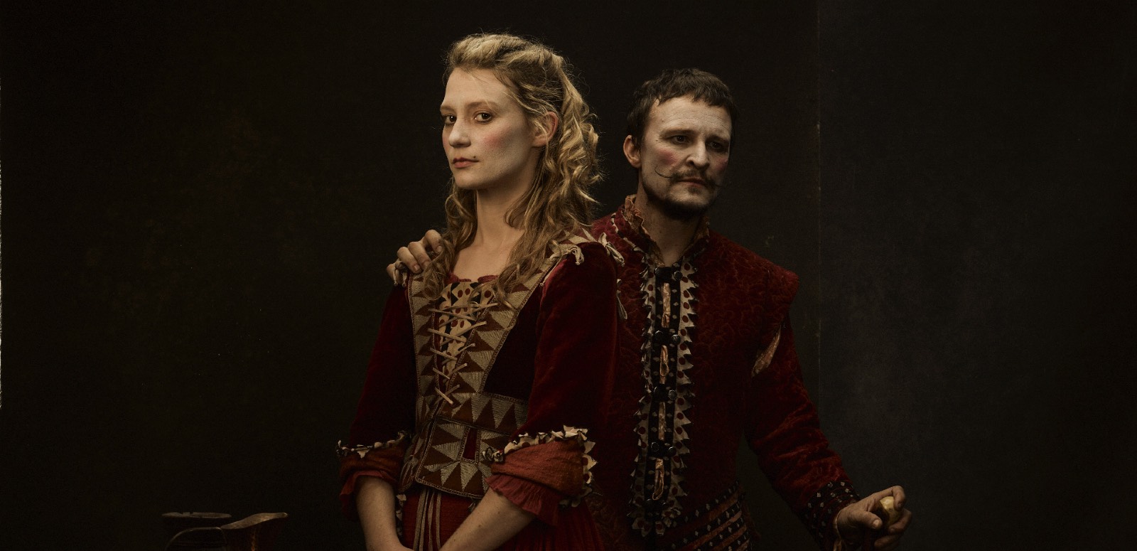 Mia Wasikowska and Damon Herriman standing shoulder to shoulder dressed in 17th century costume in the film Judy & Punch