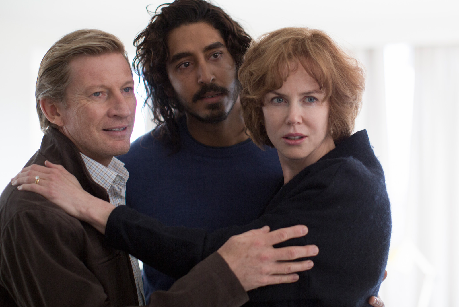 David Wenham, Dev Patel and Nicole Kidman holding on to each other in an affectionate family pose from the movie Lion