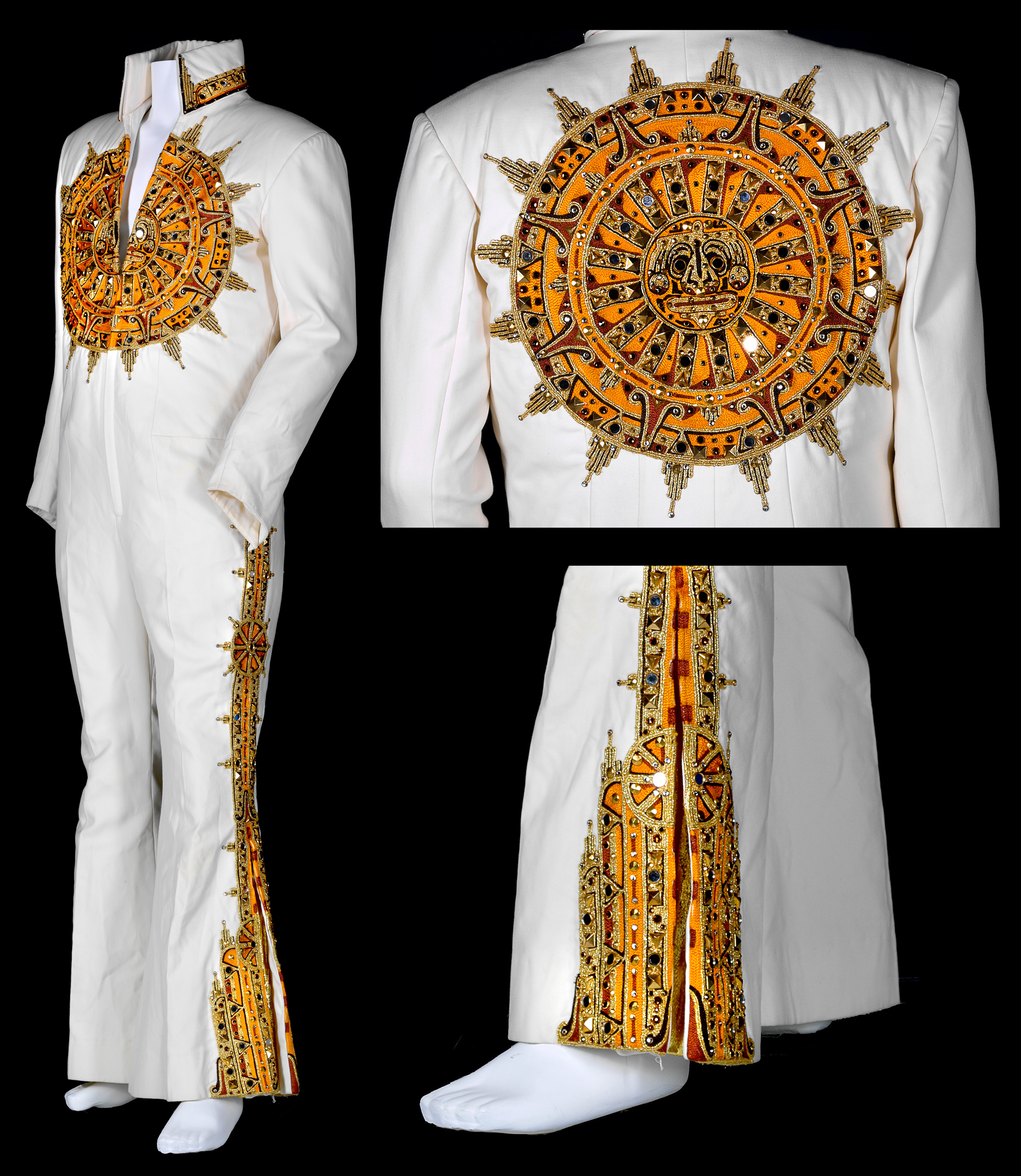 A white jumpsuit with Aztec-style embroidered detail in the shape of a sun on the front and back. There is also detail on the outside pants leg.
