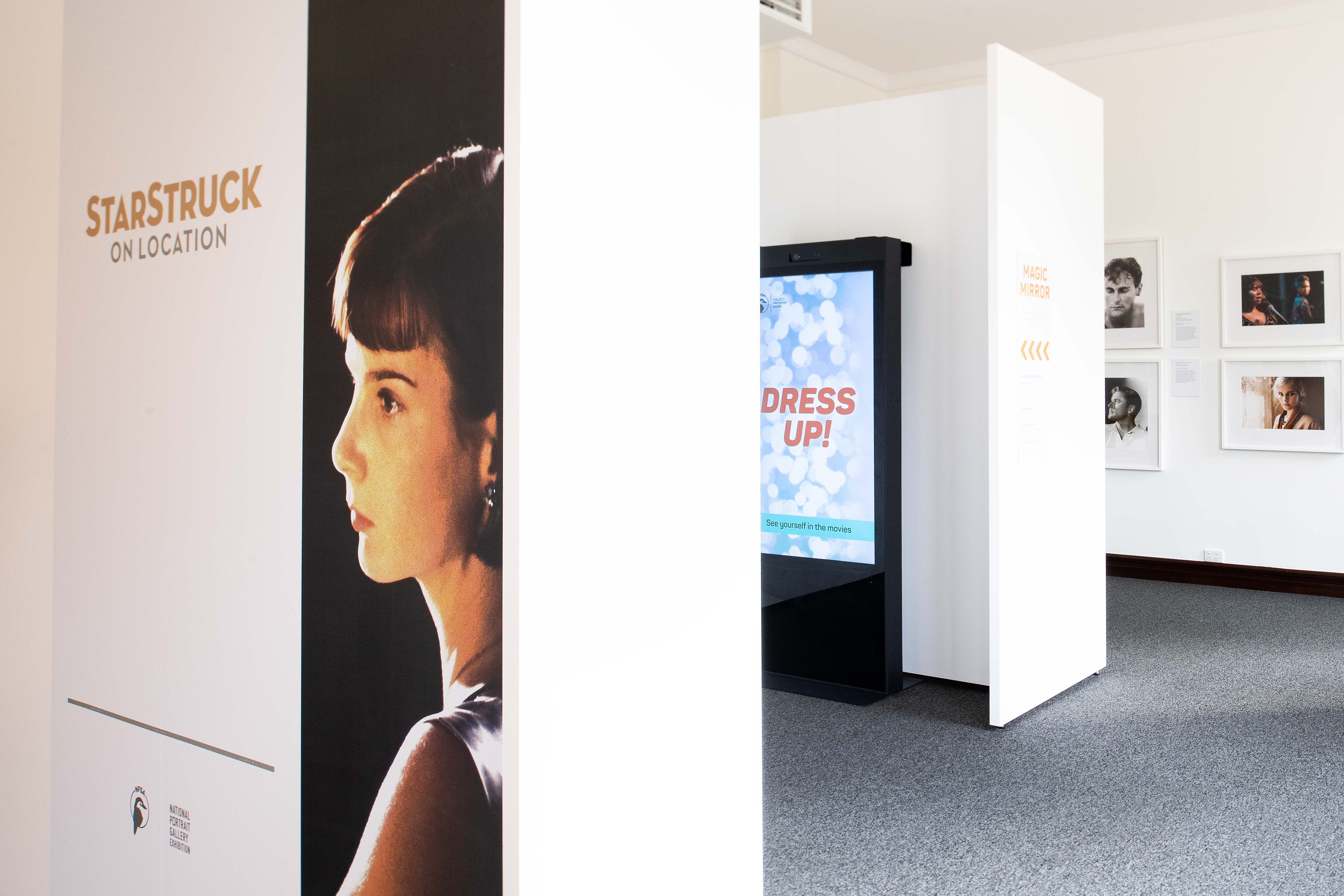 Starstruck: On Location exhibition room view featuring Rachel Griffiths as Lucy in Cosi by Mark Joffe, the Magic Mirror digital interactive and portraits of iconic Australia actors.