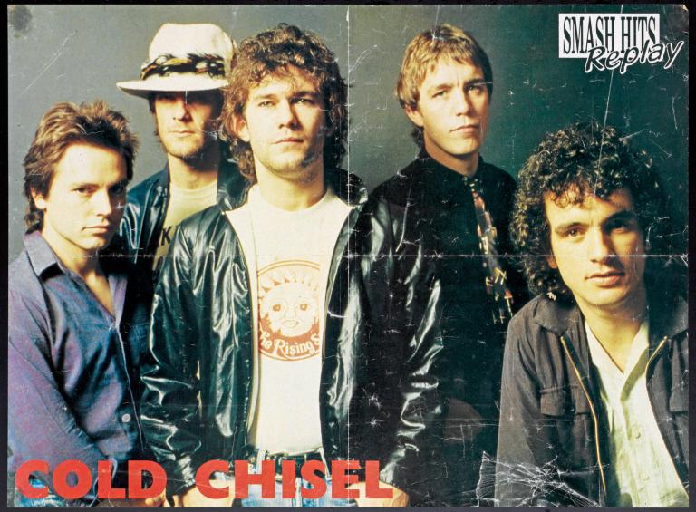 Poster with 'Cold Chisel' in red block letters at bottom left and the magazine name 'Smash Hits Replay' top right. Cold Chisel band members are pictured against a dark background. L to R: Phil Small, Don Walker, Jimmy Barnes, Steve Prestwich and Ian Moss.