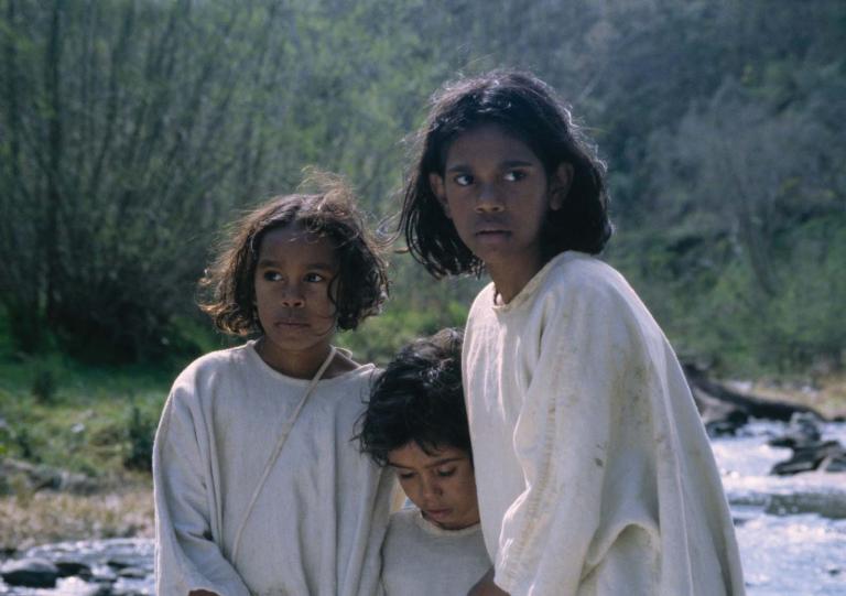 Molly, Gracie and Daisy walking through a creek bed in a still from the film Rabbit-Proof Fence.