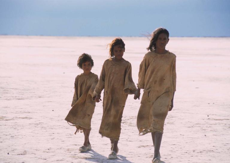 Three girls walk across a salt pan in a still from the film Rabbit-Proof Fence.