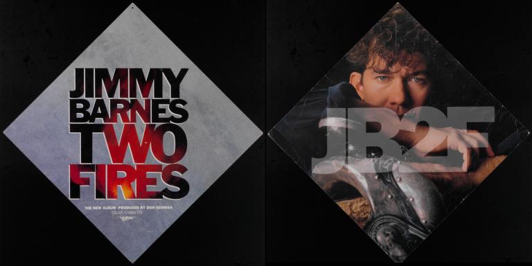 Display card with black background split into two sections. On the left is a grey diamond shape with the writing "Jimmy Barnes Two Fires" and on the right is another diamond shape with an image of Jimmy Barnes inset and a watermark over the top - JB2F.