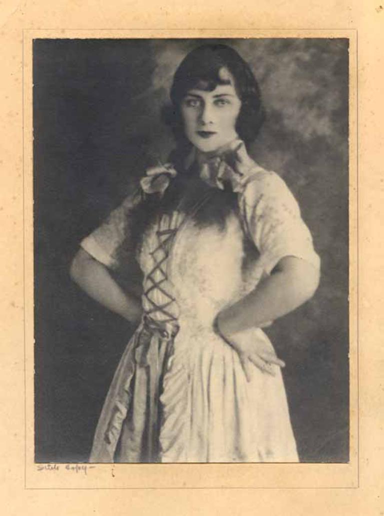 Three quarter length photograph of silent filmmaker Phyllis McDonagh posing for camera with her hands on her hips.