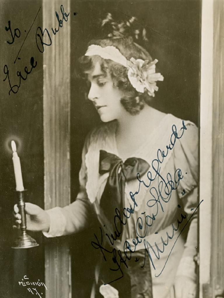 Frances Alda holding a lit candle.
