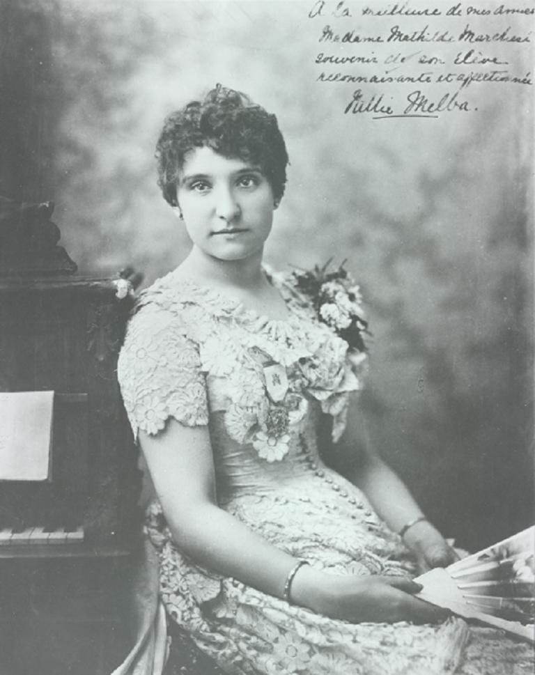 Nellie Melba seated and holding a fan.