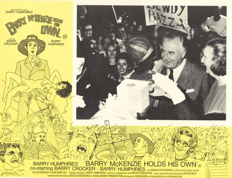 A lobby card for the film Barry McKenzie Holds His Own shows the back of Dame Edna Everage's head as she kisses Gough Whitlam. Margaret Whitlam stands next to Gough.