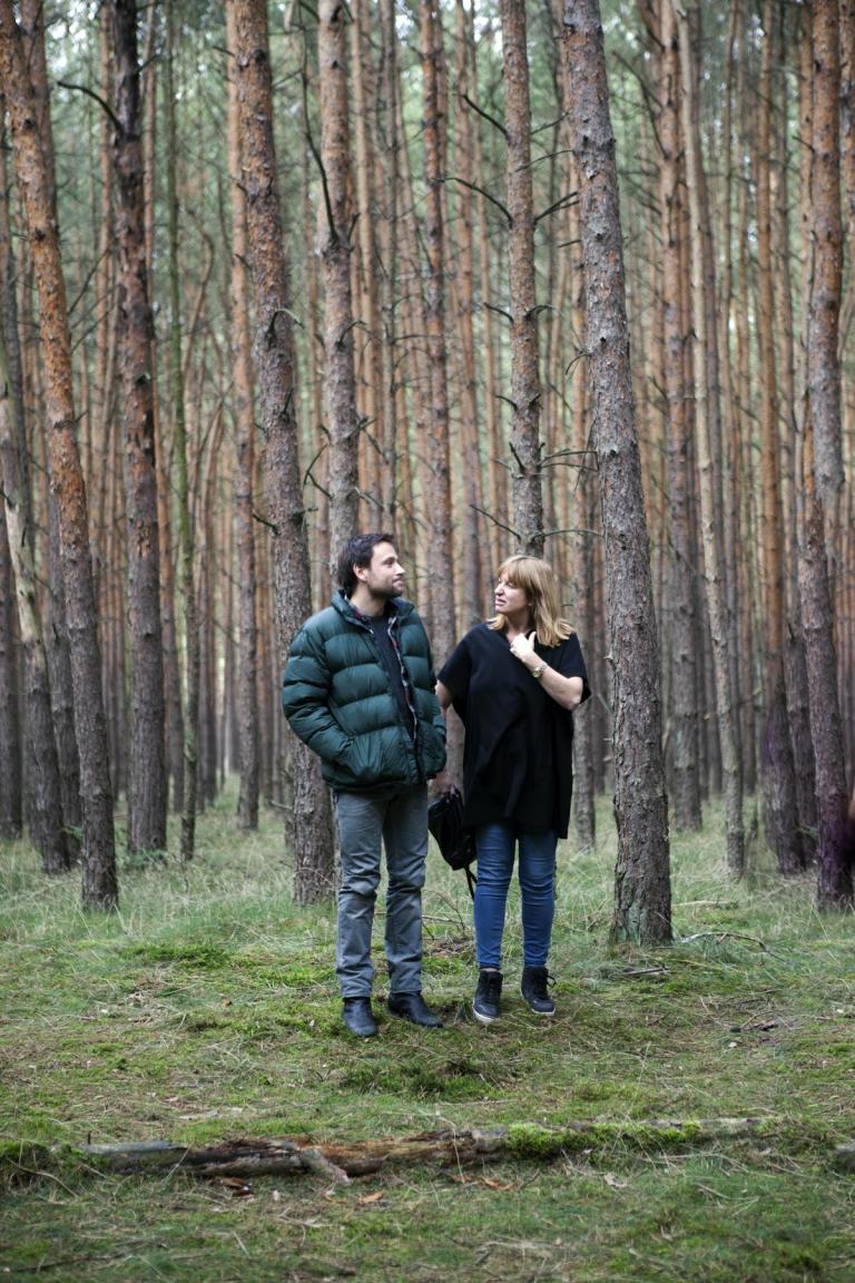 Director Cate Shortland works with actor Max Rielmelt in a forest location in Germany.