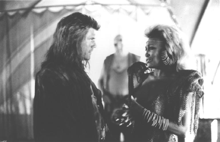 Mel Gibson (Max) listening to Tina Turner (Aunty Entity) in Mad Max Beyond Thunderdome.