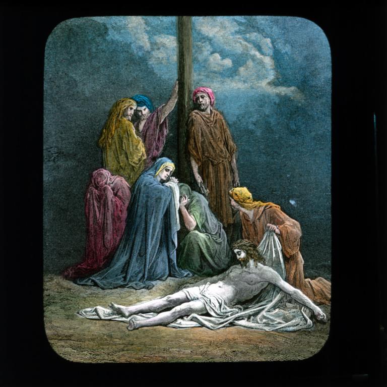 Christ laying dead on the ground surrounded by mourners