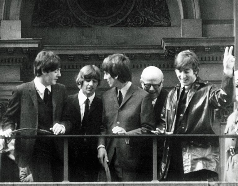 The Beatles address crowds in Melbourne from the balcony of the Melbourne Town Hall in 1964, along with the Lord Mayor of Melbourne.