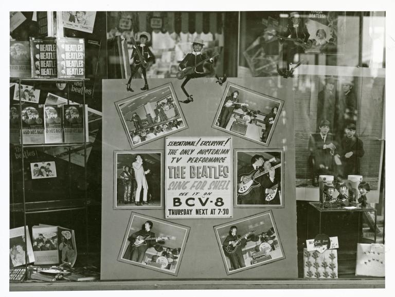 Bendigo record store window display promotes The Beatles appearance on television. The promo reads 'THE BEATLES SING FOR SHELL' and the display includes photographs and memorabilia.