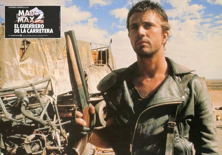 Mad Max 2 lobby card featuring Max (Mel Gibson) holding a sawn-off shotgun