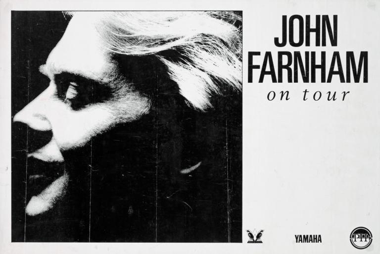 Close up of John Farnham's face in profile on a poster. The right hand side of the poster says John Farnham on tour