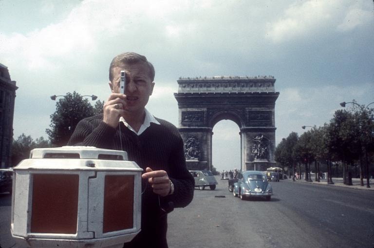Graham Kennedy taking photos on the Avenue des Champs-Élysées, Paris, with the Arc de Triomphe