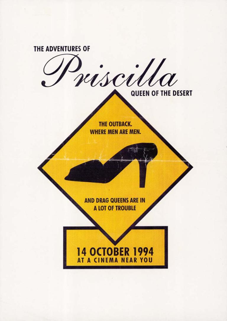 Title at top in black text. Underneath silhouette of a stiletto on a yellow background similar to a roadsign. Text reads 'The outback. Where men are men. And drag queens are in a lot of trouble'. Release date in yellow box at bottom.