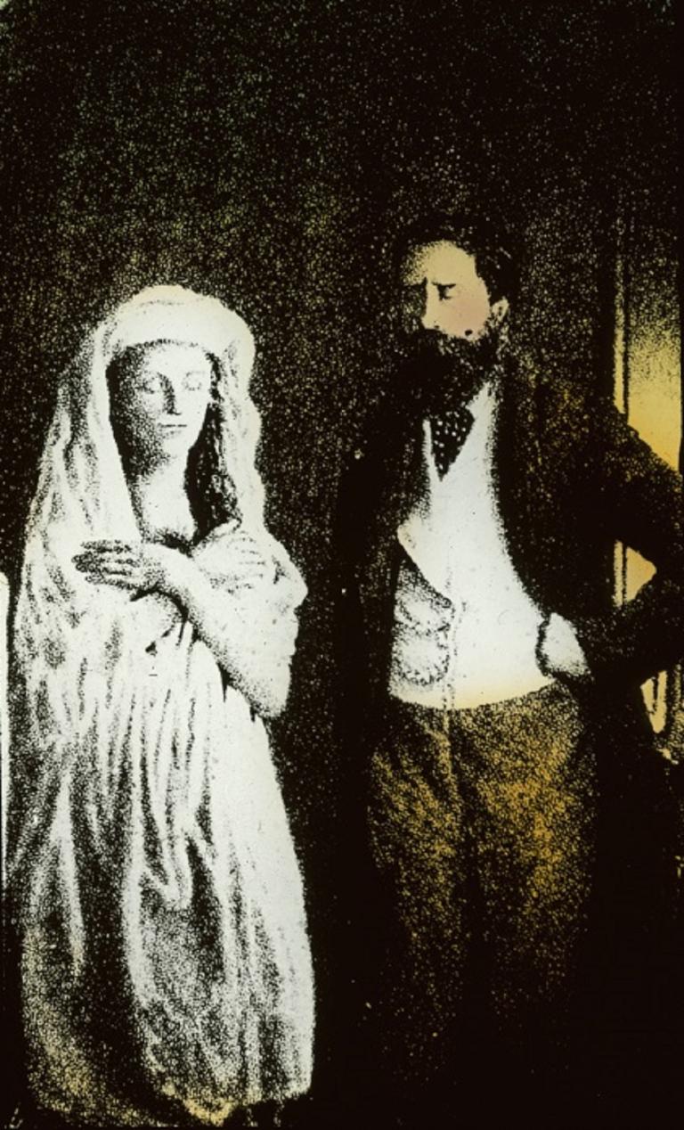 Colour glass slide showing a man standing with hands on his hips, looking at a spirit in a white robe with hands crossed over her chest.