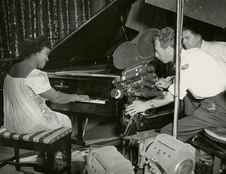 Winifred Atwell being filmed while playing the piano