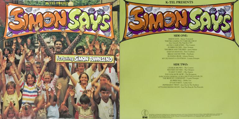 A record sleeve for an album titled Simon Says. On the cover is the title at the top in big flouro-coloured orange and green letters and below that is a picture of Simon Townsend surrounded by kids. Everyone has their hands stretched up in the air.
