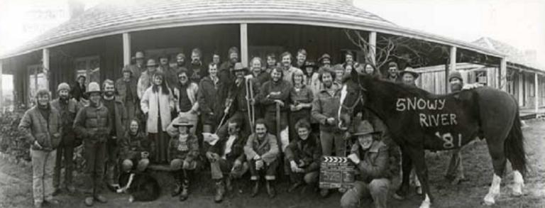 Panoramic shot of the cast and crew from the film including a horse with 'Snowy River 1981' painted on its side