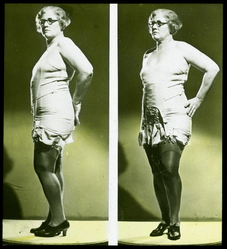A side-by-side comparison of a woman wearing underwear from two different angles. The slide is hand-coloured.