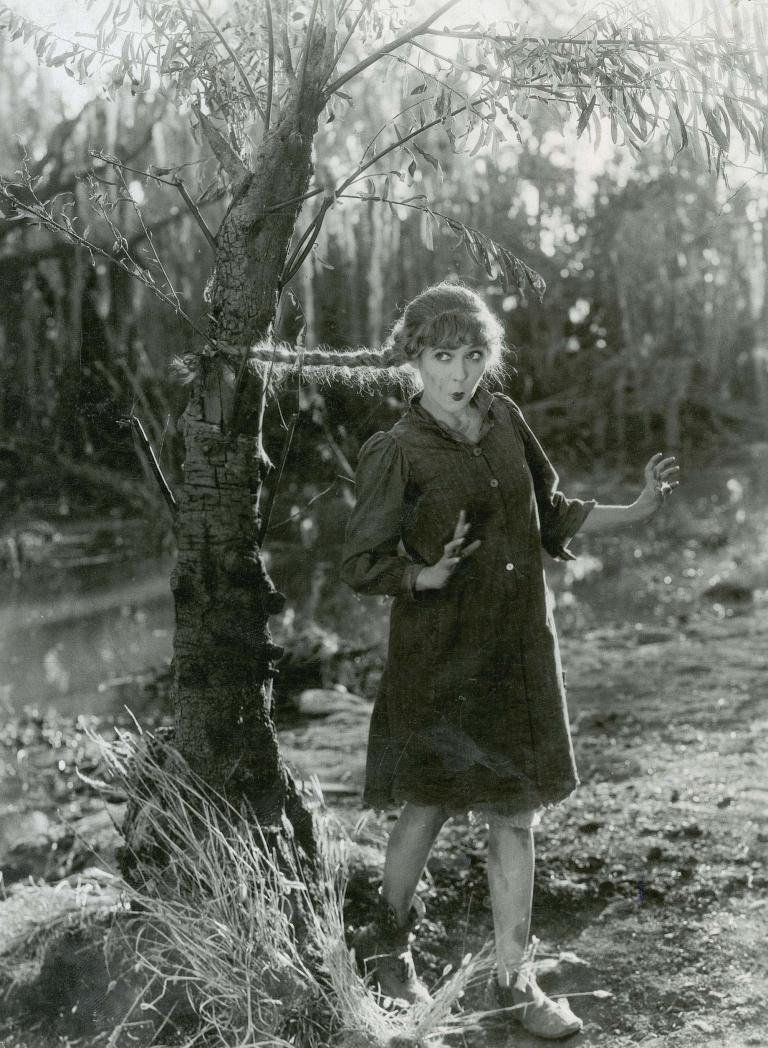 Mary Pickford is surprised when her plait catches on a tree in a still from the film Sparrows, 1926.