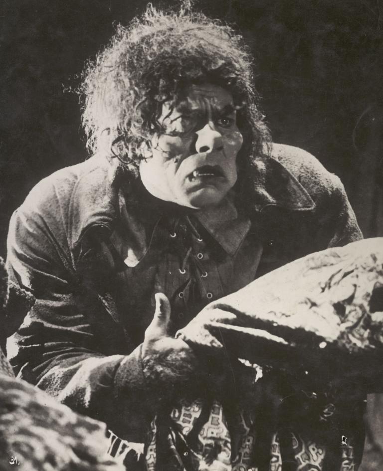 Lon Chaney in heavy make-up as the Hunchback and looking anguished in a still from the film The Hunchback of Notre Dame, 1923.