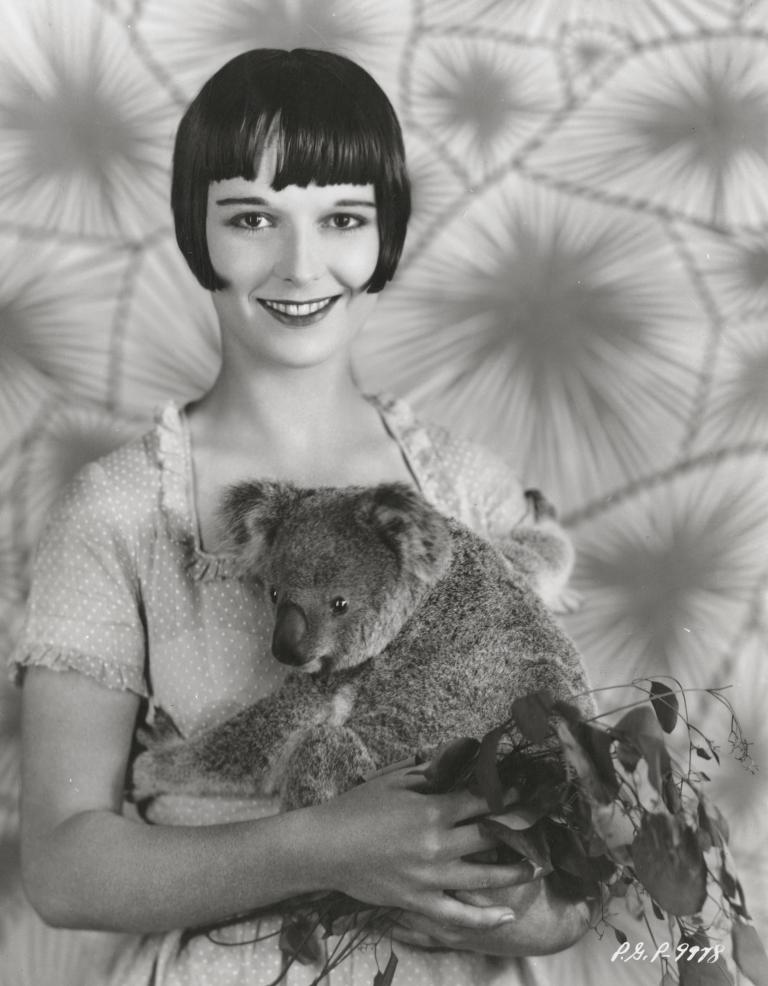 Louise Brooks holds Archie the koala in a studio publicity still, 1928.