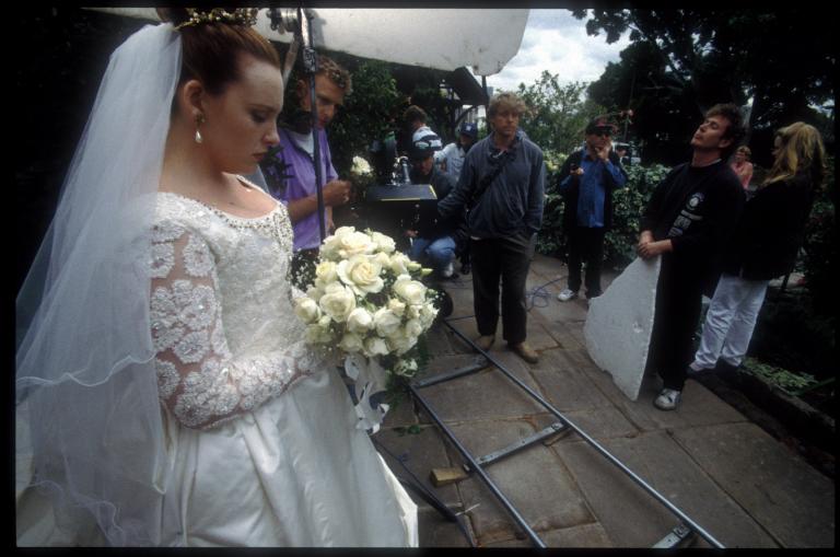 Muriel (Toni Collette) in wedding dress outside the Church