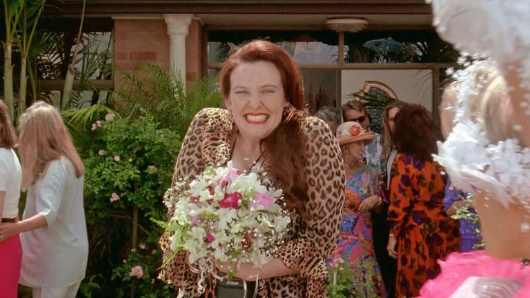 Muriel (Toni Collette) catches the bouquet at Tania's (Sophie Lee) wedding