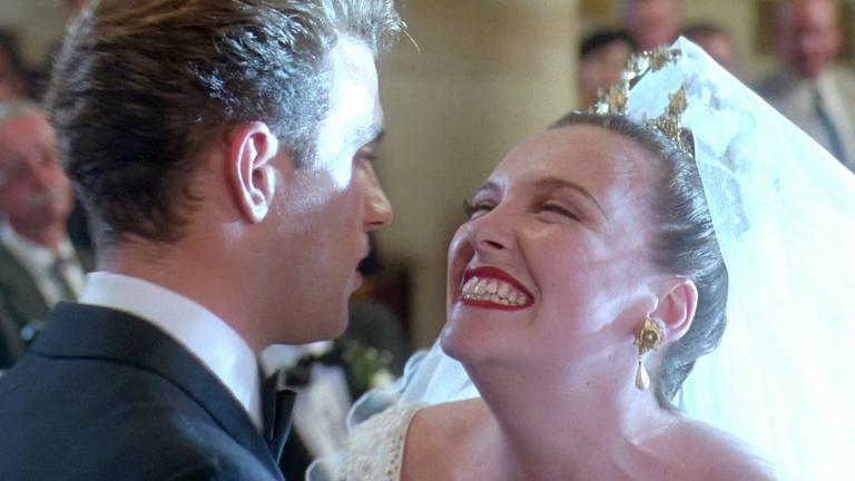 Close up Muriel (Toni Collette) beaming at new husband David (Daniel Lapaine)