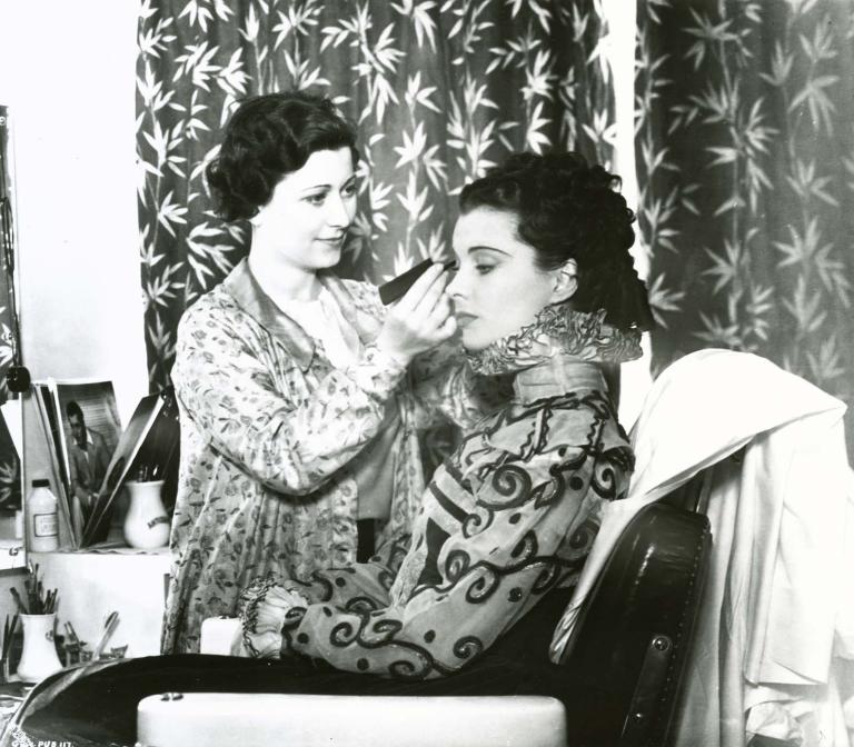 A woman applies make-up to Vivien Leigh during the filming of Fire Over England in 1937