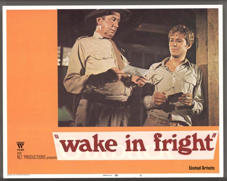 Chips Rafferty and Gary Bond talk in a scene from the film Wake in Fright