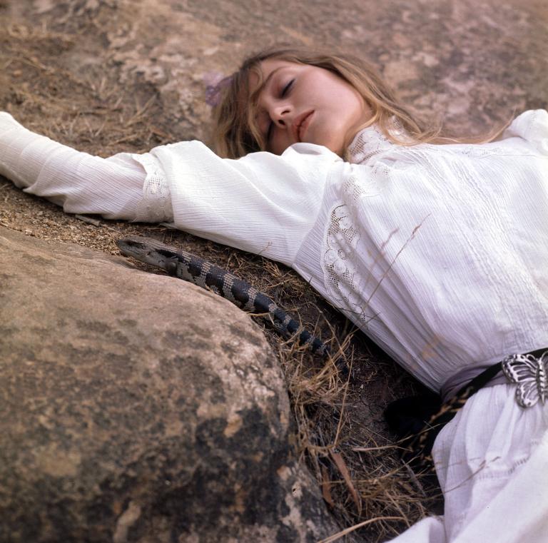 Miranda (Anne Lambert) unconscious on the rock