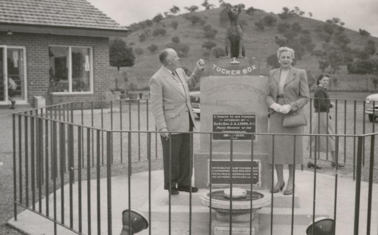 Jack O'Hagan standing beside a statue of the dog on the tuckerbox in Gundagai.
