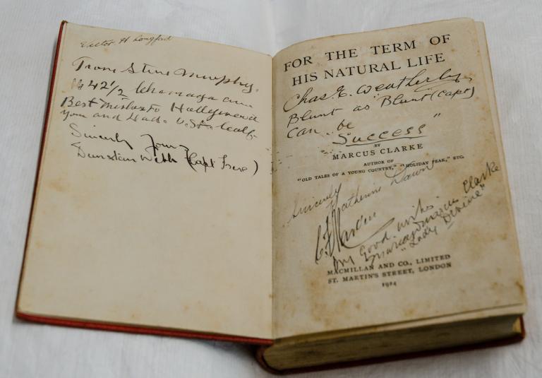 Inside cover of a copy of the novel For the Term of His Natural Life which has been autographed by people.