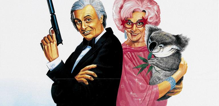An illustration of Barry Humphries as both Les Patterson and Dame Edna Everage. They stand back to back. Les holds a gun with silencer. Edna holds a koala. Her hair is pink. She wears pink sparkly glasses.