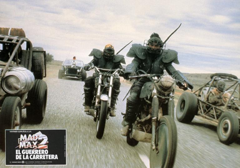 Mad Max 2 lobby card featuring heavily costumed stunt men on motorbikes.