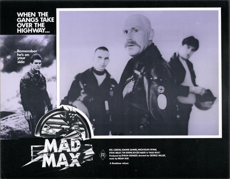 Lobby card for Max Max shows Fifi MacAffee (Roger Ward) and two others in leathers with bike helmets