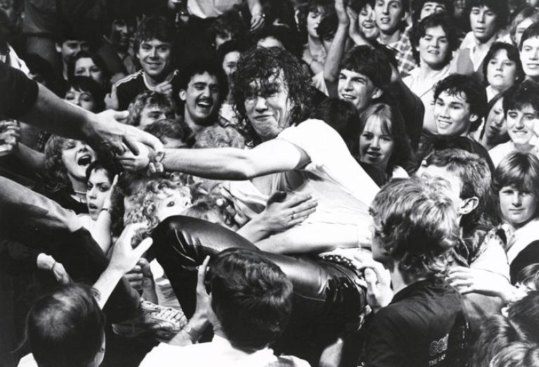 Lead singer of Cold Chisel, Jimmy Barnes, in a crowd of fans during a concert.