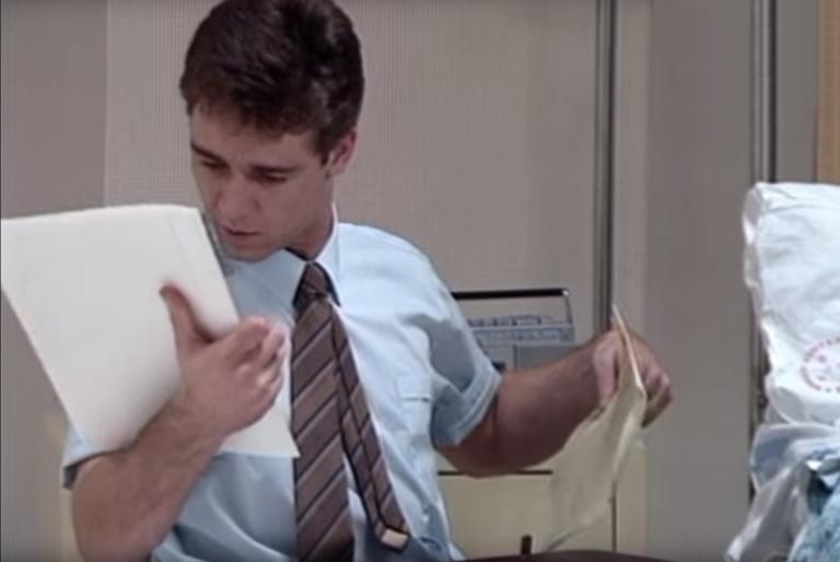 A young Russell Crowe looking at paperwork, as part of a role playing exercise, in the short film Manager on the Case