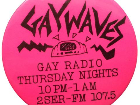 A pink badge with the words: Gaywaves, gay radio, Thursday nights, 10pm - 1am, 2SER-FM 107.5 with a pen drawing of a radio in the centre