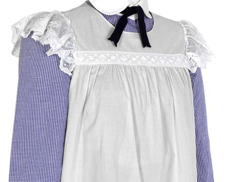 Detail of blue and white pinafore film costume worn by Sara in Picnic at Hanging Rock