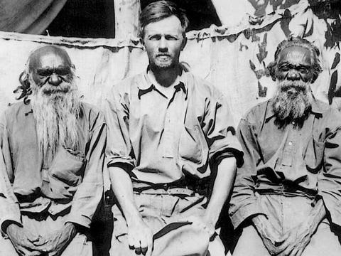 Anthropologist Ted Strehlow sitting with two older Indigenous men.  