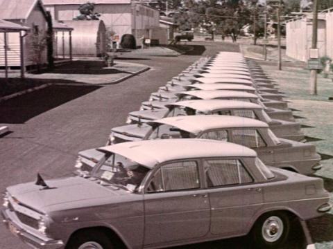 A long row of 1960 Holden sedans