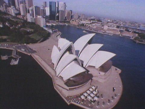 Overhead shot of the Sydney Opera House, with Circular Quay and the city in the background.