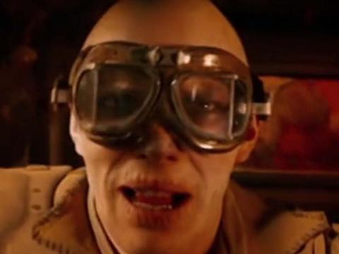 A close-up of Nux, a War Boy from Mad Max: Fury Road, who wears giant goggles and white face make-up
