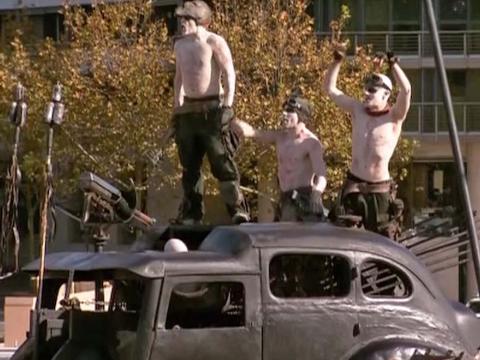 Stunt performers stand on vehicles from Mad Max Fury Road