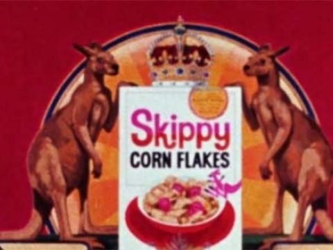 An advertising graphic of a coat of arms with a box of Skippy cornflakes at the centre, topped with a crown and flanked by two kangaroos